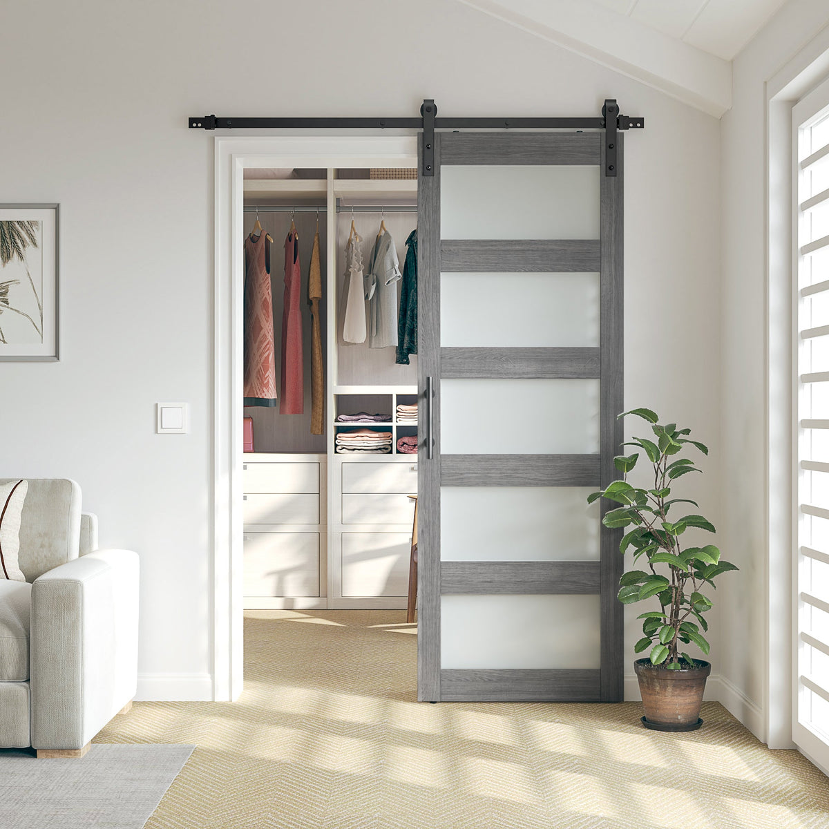 Gray wood-look barn door with five frosted glass panels and black hardware, open in front of a closet